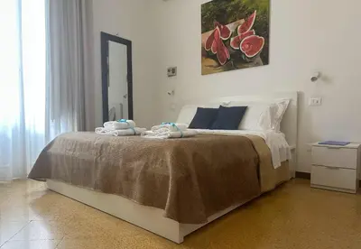 a bedroom with a bed with towels on it at YooRoom in Palermo
