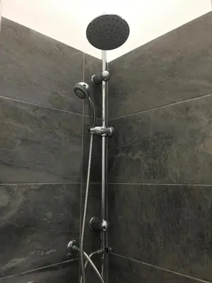 a shower with a shower head in a bathroom at YooRoom in Palermo
