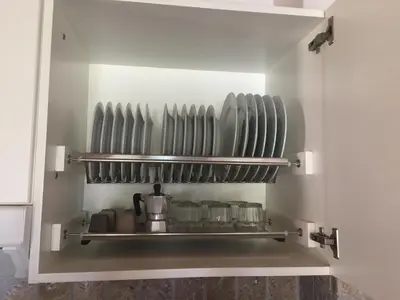 a shelf in a kitchen with pots and pans at Casa del Sale, a 50 m dalla spiaggia in Lascari