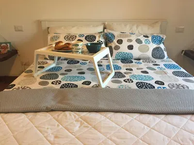 a bed with a tray of food on it at Casa del Sale, a 50 m dalla spiaggia in Lascari