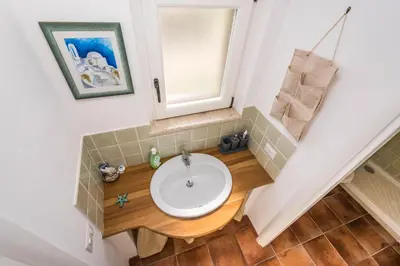 a bathroom with a sink and a mirror at Casa del Sale, a 50 m dalla spiaggia in Lascari