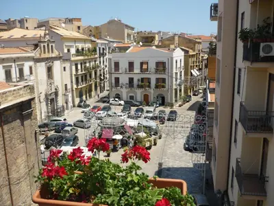 a view of a city street with cars and flowers at Guest House Beati Paoli in Palermo