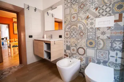 a bathroom with a toilet and a sink at Caleidoscopica Bahlara Ballarò in Palermo