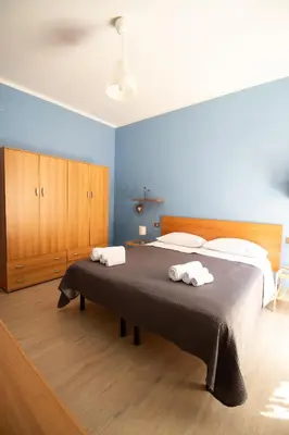 a bedroom with a bed with two towels on it at Caleidoscopica Bahlara Ballarò in Palermo