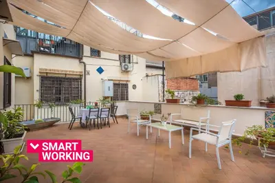 a patio with tables and chairs under a tent at Casa d'arte Ugdulena con Piscina e Terrazza by Wonderful Italy in Palermo