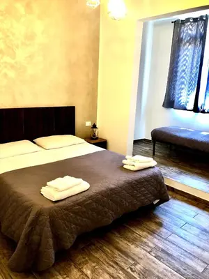 a bedroom with a bed with two towels on it at Il Genoardo Della Zisa in Palermo
