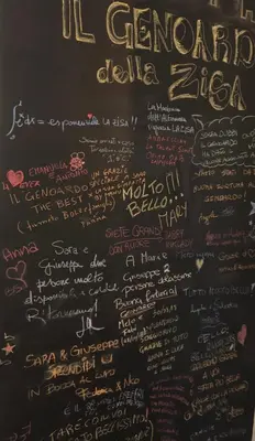 a chalkboard with writing on a wall at Il Genoardo Della Zisa in Palermo