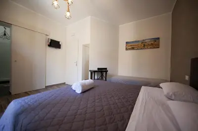 a bedroom with a large bed and a television at Il Genoardo Della Zisa in Palermo