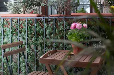 a wooden bench and a potted plant on a balcony at Ai Mori in Palermo