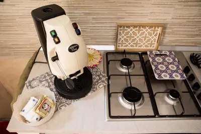 a model of a coffee maker sitting on top of a stove at Casa Assisi in Palermo