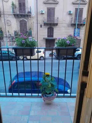 a balcony with two potted plants on a fence at Casa Assisi in Palermo