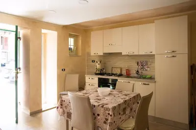 a kitchen with a table and chairs and a kitchen with a table and a table at Casa Assisi in Palermo