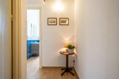 a hallway with a small table and a window at Le Casette Di Maria Pia in Mondello