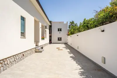 an alley between two white buildings at Le Casette Di Maria Pia in Mondello