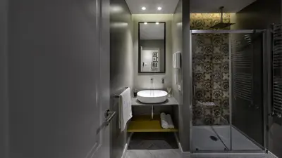 a bathroom with a sink and a shower at Suite del Ponte Normanno in Palermo