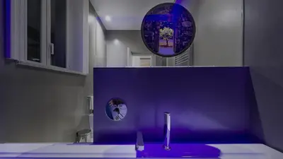 a bathroom with a purple sink and a mirror at Suite del Ponte Normanno in Palermo