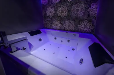 a bath tub with purple lighting in a room at Suite del Ponte Normanno in Palermo