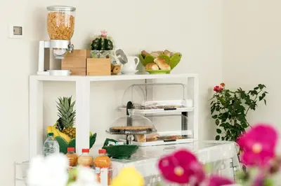 a white shelf with food and other items on it at Affittacamere Sirius in San Vito lo Capo