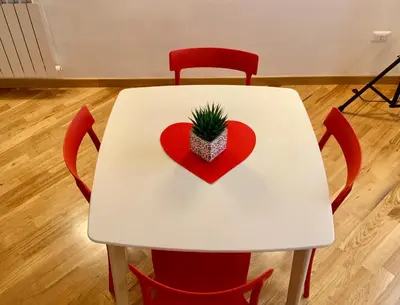 a white table with a heart and a plant on it at WelcHomeLoft in Palermo