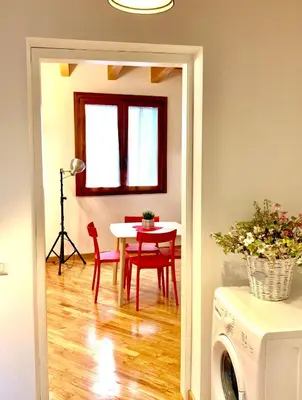 a dining room with a table and a table and chairs at WelcHomeLoft in Palermo
