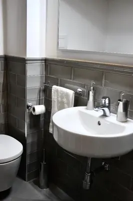 a bathroom with a sink and a toilet at WelcHomeLoft in Palermo