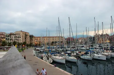 a group of boats docked in a harbor with buildings at WelcHomeLoft in Palermo