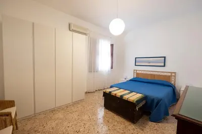 a bedroom with a bed and a large closet at Casa Lisa a due passi dal mare con ampio giardino in San Vito lo Capo