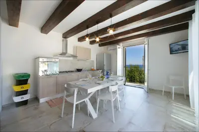 a kitchen with a table and chairs in a room at Villa Antonia - Vasca Idromassaggio Terrazza Vista Mare in San Vito lo Capo