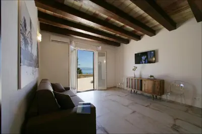 a living room with a couch and a view of the ocean at Villa Antonia - Vasca Idromassaggio Terrazza Vista Mare in San Vito lo Capo