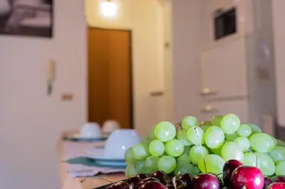 a pile of green grapes and other fruit on a table at Casa Salinas Centro Storico in Palermo