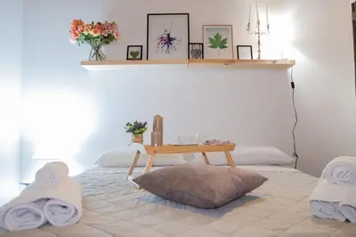 a bedroom with a bed with a table on it at Casa Salinas Centro Storico in Palermo