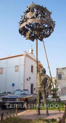 a statue of a man holding up an umbrella at GíeffeHOUSE in Terrasini