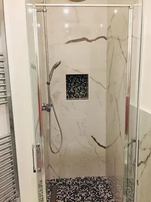 a shower with a glass door in a bathroom at CLUVERIO11 LUXURY APARTMENT in Palermo