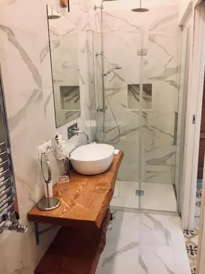 a bathroom with a sink and a shower at CLUVERIO11 LUXURY APARTMENT in Palermo