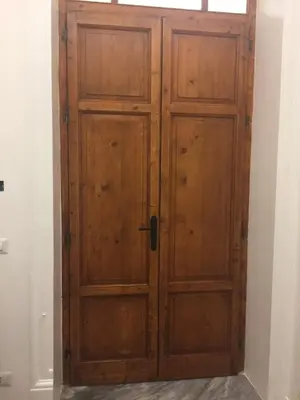 a pair of wooden doors in a room at CLUVERIO11 LUXURY APARTMENT in Palermo