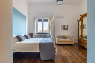 a bedroom with a bed and a couch in it at 90100 in Palermo