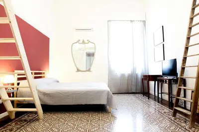 a bedroom with two bunk beds and a mirror at 90100 in Palermo