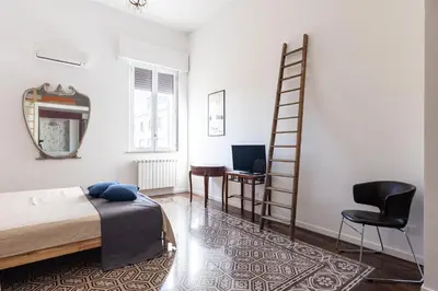 a bedroom with a bed and a ladder and a desk at 90100 in Palermo