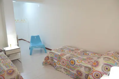 a bedroom with a bed and a blue chair at Casa DahLia Mondello in Mondello