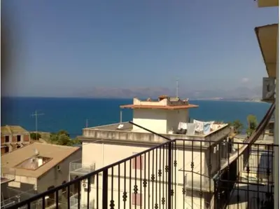 a balcony of a building with the ocean in the background at Mare e Relax in Castellammare del Golfo