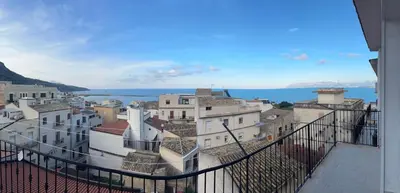 a view of buildings and the ocean from a balcony at Mare e Relax in Castellammare del Golfo