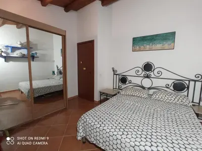 a bedroom with a bed and a large mirror at Villa Ancora in Campofelice di Roccella