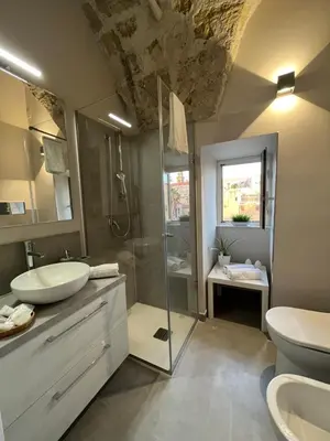 a bathroom with a sink and a shower and a toilet at Appartamento Valverde in Palermo