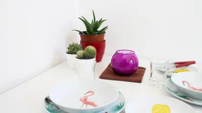 a white table with dishes and plants on it at Beach House Mondello in Mondello