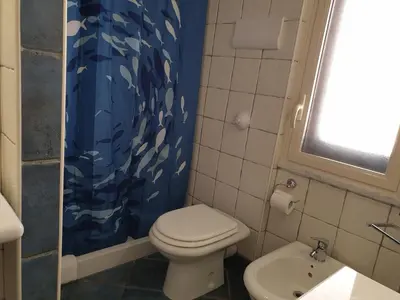 a bathroom with a toilet and a sink at Casa Maro' in Palermo