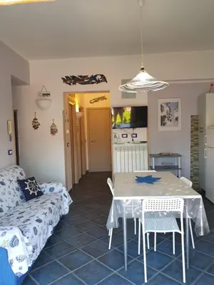 a living room with a table and a couch at Casa Maro' in Palermo