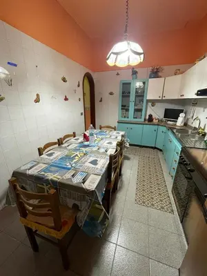 a kitchen with a table and chairs in a room at Big Mom House in Palermo