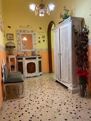a living room with a fireplace and a mirror at Big Mom House in Palermo