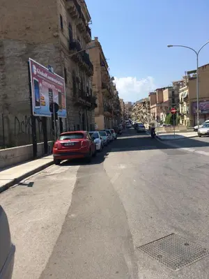 a red car parked on the side of a street at Big Mom House in Palermo