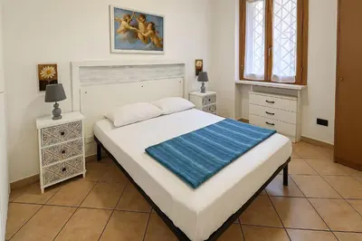 a bedroom with a large bed and two night stands at Appartamenti Penelope in Mondello